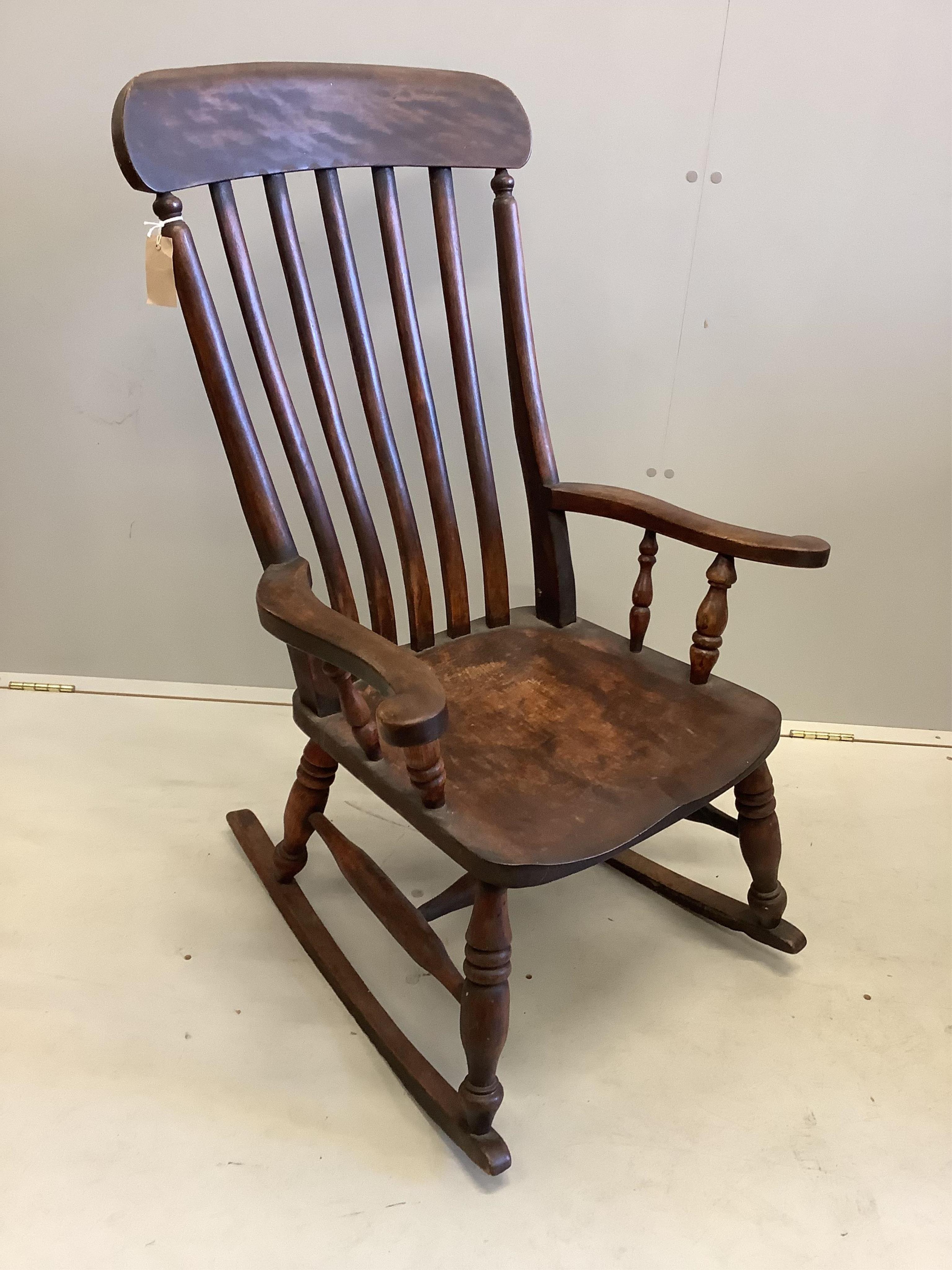 A Victorian elm and beech Windsor lathe back rocking chair, width 63cm, depth 45cm, height 102cm. Condition - fair